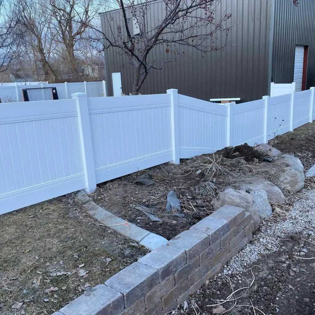 Two-tone vinyl privacy fence installed at a Herriman home