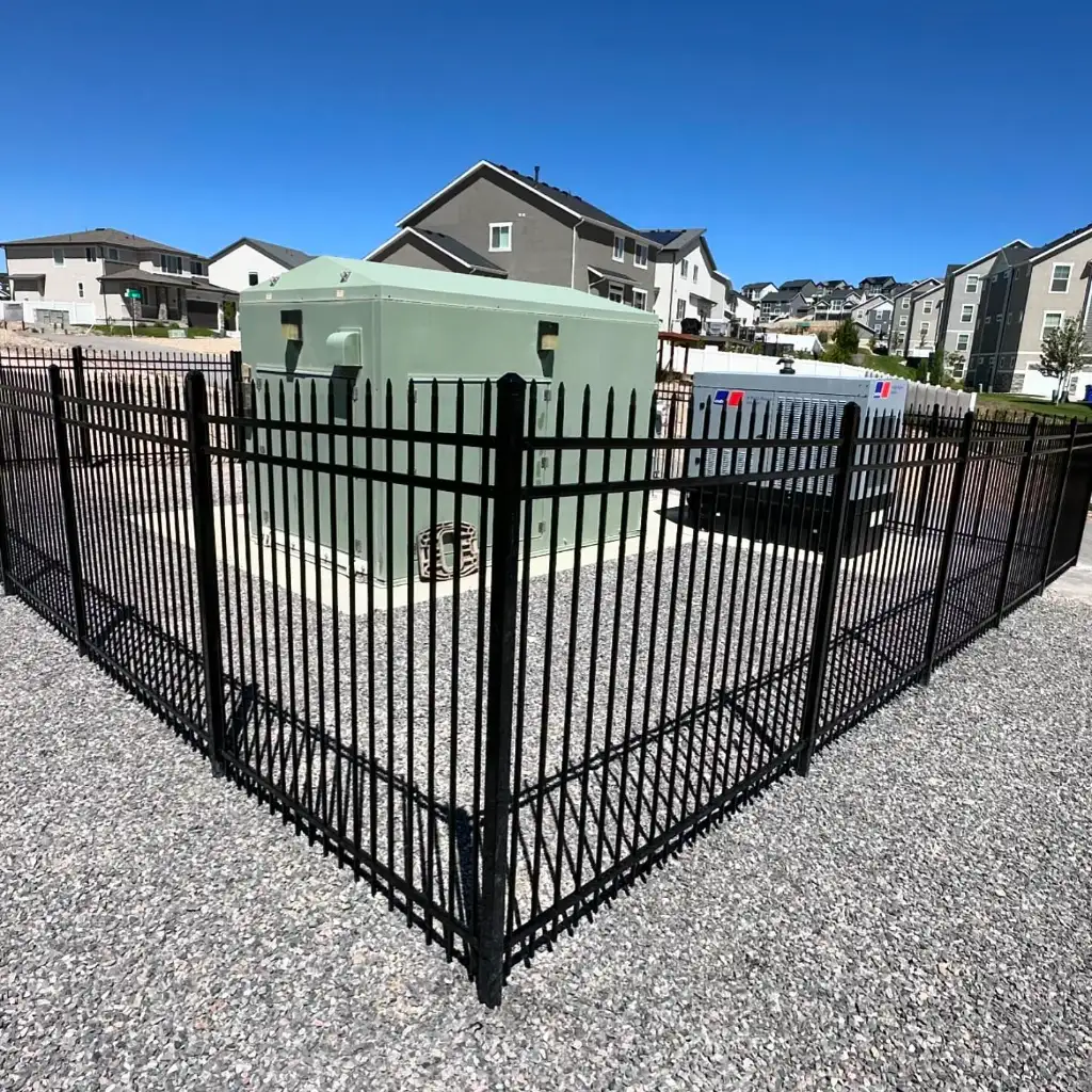 Black steel double gate installed across a residential driveway