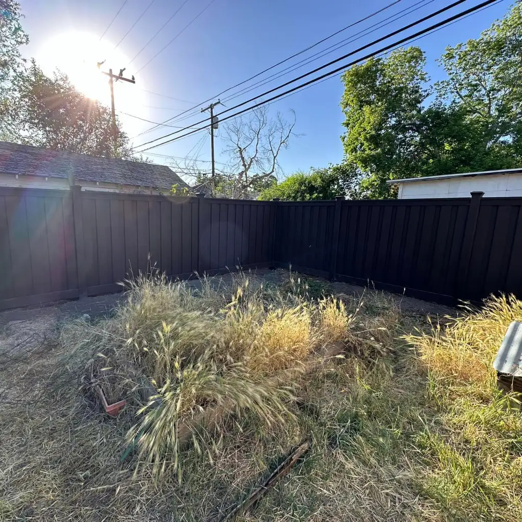 Dark composite privacy fence with a clean framed finish around a Utah backyard