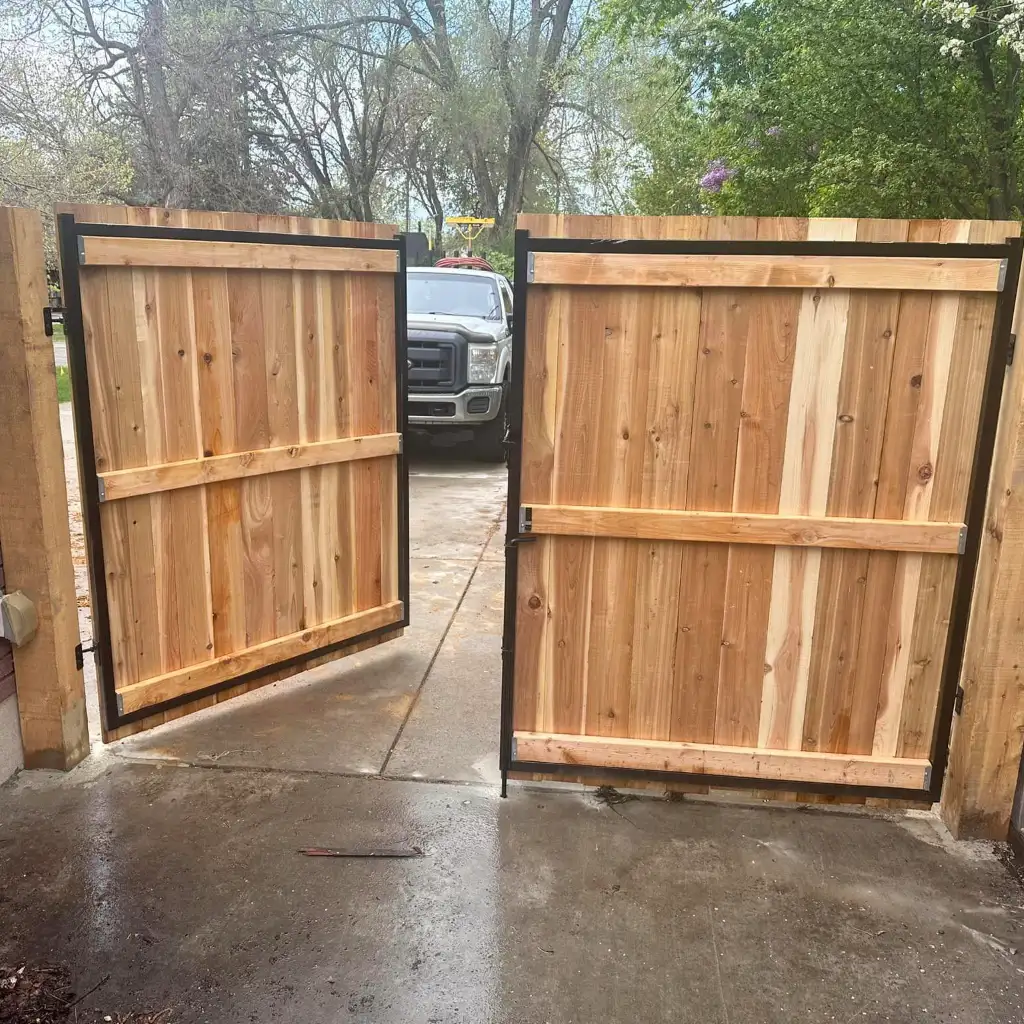 New wood fence and gate installed beside a landscaped Utah yard