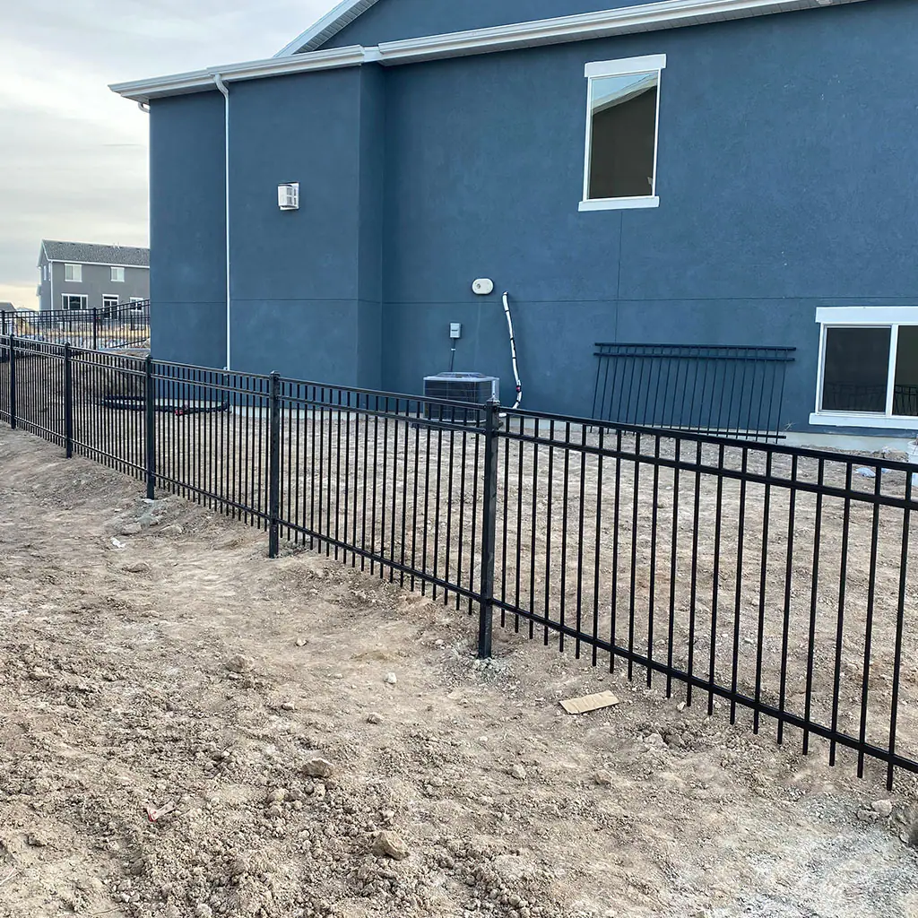 Black ornamental iron fence around a landscaped Utah property
